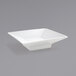 A Front of the House bright white square porcelain sauce dish with a handle.