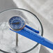 A blue AvaTemp pocket probe thermometer in a glass of water.