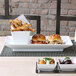 A close up of a white Front of the House Kyoto rectangular porcelain plate with a sandwich on it.