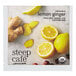 A package of Steep Cafe Organic Lemon Ginger Tea pyramid sachets on a white surface with a slice of ginger and a cut lemon.