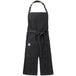 A black denim Mercer Culinary apron with pockets and an adjustable neck.