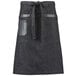 A black Mercer Culinary bistro apron with black leather details and pockets on a counter.