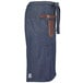 A Mercer Culinary Draper Denim Bistro Apron with brown leather details.