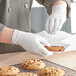 A person wearing Noble Nitrile gloves holds a cookie.