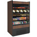 A Structural Concepts Oasis air curtain merchandiser filled with various drinks on shelves.