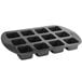 A black Wilton brownie pan with 12 square compartments.