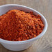A bowl of Cattlemen's Chili Lime BBQ Rub, a red powder.