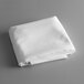 A folded white Intedge rectangular table cloth.