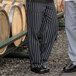 Two men wearing Uncommon Chef black and white striped cargo chef pants.