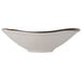 A white Tuxton china bowl with a gold rim.