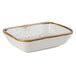 A white rectangular Tuxton china side dish with brown speckles.
