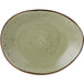A white Tuxton china ellipse plate with a green and brown geode spiral pattern.