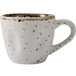 A white coffee cup with brown speckles.