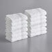 A stack of white Lavex Luxury washcloths.