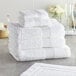 A stack of Lavex Luxury white wash cloths.