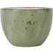 A TuxTrendz Artisan Geode Olive bouillon cup with brown specks on a metal surface.