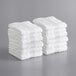 A stack of white Lavex Luxury hand towels.