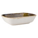 A white rectangular china bowl with brown specks.