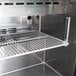 A metal shelf in a Turbo Air refrigerated sandwich prep table.