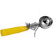A yellow and silver Hamilton Beach ice cream scoop with a thumb press.