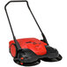 A red and black Bissell Commercial Battery Powered Triple Brush Power Sweeper.