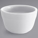 A white Tuxton China bouillon bowl with a curved rim.