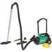 A green and black Bissell Commercial canister vacuum with hose.