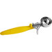A yellow Hamilton Beach ice cream scoop with a silver thumb press and ergonomic handle.
