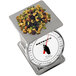 A Cardinal Detecto stainless steel portion scale with nuts on top.