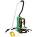A green and black Bissell Commercial backpack vacuum cleaner with a hose.