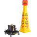 A yellow cone with a black and yellow Bissell HURRICONE strap next to a yellow caution sign.