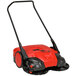 A red and black Bissell Commercial battery powered floor sweeper.