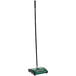 A green and black Bissell floor sweeper with a black pole.