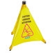 A yellow Carlisle wet floor "caution" cone with black text and a red triangle sign.
