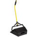 A black and yellow Rubbermaid upright wet/dry pan with a handle.