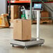 A cardboard box sits on an AvaWeigh digital receiving bench scale.