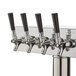 A stainless steel Assure beer tower with four taps.