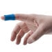 A close-up of a person's finger with a blue Medique adhesive strip bandage.