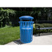An Ex-Cell Kaiser blue gloss outdoor recycling receptacle with white text next to a black bench.
