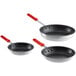 A group of three Choice aluminum non-stick frying pans with red silicone handles.