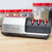 A black and red Edgecraft Chef's Choice M2130 3 Stage Asian Style knife sharpener module on a counter.
