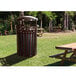 A Ex-Cell Kaiser coffee gloss outdoor trash can on a wooden picnic table in a park.