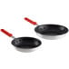 Two Choice aluminum frying pans with red silicone handles.