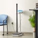 An AvaWeigh digital physician scale next to a blue chair.