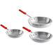 A group of silver aluminum frying pans with red silicone handles.