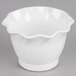 A white Cambro polycarbonate bowl with a wavy edge.