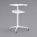 A white Safco adjustable height stand-up workstation with wheels.