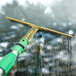 A window cleaner with a green and gold Unger GoldenClip squeegee.