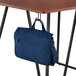 A black Safco accessory hook holding a blue bag on a metal stand.