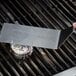 A hand uses a CDN GTS800X Pro-Accurate Dial Grill Thermometer on a grill.